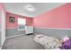 Cozy bedroom features wall trim and a large window providing natural light at 2791 Quarterland St, Strasburg, CO 80136
