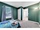 Cozy bedroom with large window and adjacent closet and connected bathroom at 2791 Quarterland St, Strasburg, CO 80136