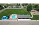 Aerial view of community pool, playground, and picnic pavilion offering recreational amenities in a well-maintained neighborhood at 2791 Quarterland St, Strasburg, CO 80136