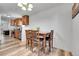 Dining area featuring a wooden table with chairs, adjacent to an updated kitchen at 2791 Quarterland St, Strasburg, CO 80136