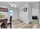 Bright dining room with door to exterior and view to hallway and adjacent bedroom at 2791 Quarterland St, Strasburg, CO 80136