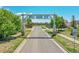 Entrance to Wolf Creek Run with mature trees, sidewalks and green spaces at 2791 Quarterland St, Strasburg, CO 80136