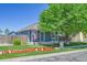 Charming single-story home with mature tree, front porch, and an American flag at 2791 Quarterland St, Strasburg, CO 80136
