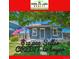 Charming single-story home featuring a cozy front porch, complemented by an American flag and lush green lawn at 2791 Quarterland St, Strasburg, CO 80136