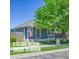 Charming blue house with lush front yard, mature tree, American flag, and inviting front porch at 2791 Quarterland St, Strasburg, CO 80136