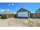 View of garage with fence and driveway at 2791 Quarterland St, Strasburg, CO 80136