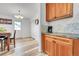 Kitchen space with wood cabinets, countertops, and view to dining area and door at 2791 Quarterland St, Strasburg, CO 80136