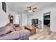 Inviting living room with wood-look floors, ceiling fan, and easy access to the bedrooms at 2791 Quarterland St, Strasburg, CO 80136
