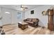 Cozy living room with wood-look floors, a ceiling fan, and neutral walls at 2791 Quarterland St, Strasburg, CO 80136