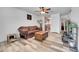 Comfortable living room with wood-look flooring, a ceiling fan, and neutral walls at 2791 Quarterland St, Strasburg, CO 80136