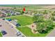 Aerial view of a park with playground, walking path, and parking area in a neighborhood at 2791 Quarterland St, Strasburg, CO 80136