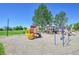 Community playground featuring slides, swings, and climbing structures on a sunny day at 2791 Quarterland St, Strasburg, CO 80136