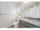 Bathroom with gray vanity, granite countertop, window, toilet, and shower with glass door at 11873 W 51St Ave, Wheat Ridge, CO 80033