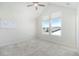 Bright empty bedroom features a large window, ceiling fan, and plush carpet at 11873 W 51St Ave, Wheat Ridge, CO 80033