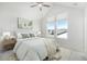 Bright bedroom features a large window, ceiling fan, and decor at 11873 W 51St Ave, Wheat Ridge, CO 80033