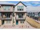 Modern townhome with stone accents, balconies, and a striking blue entry door in a new community at 11873 W 51St Ave, Wheat Ridge, CO 80033