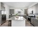 Beautiful kitchen featuring an island, stainless steel appliances, and gray cabinets at 11873 W 51St Ave, Wheat Ridge, CO 80033