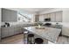 Bright kitchen featuring a large granite island, stainless steel appliances, and modern cabinetry at 11873 W 51St Ave, Wheat Ridge, CO 80033