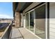 Spacious patio featuring glass sliding doors, stone columns, and iron railing at 11873 W 51St Ave, Wheat Ridge, CO 80033
