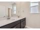 Bathroom featuring dual vanity, a large mirror, and ample natural light from a window at 14111 Deertrack Ln, Parker, CO 80134