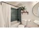 Modern bathroom featuring a shower with green tiles, sleek fixtures, and elegant decor at 1390 N Emerson St # 407, Denver, CO 80218