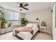 Bright bedroom featuring a metal frame bed, ceiling fan, and plants near a window at 1390 N Emerson St # 407, Denver, CO 80218