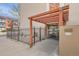 Building entrance featuring a pergola, address number, and security surveillance signage at 1390 N Emerson St # 407, Denver, CO 80218