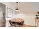 Cozy dining area featuring hardwood floors, a wooden table, and a modern light fixture at 1390 N Emerson St # 407, Denver, CO 80218