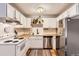 Bright kitchen featuring white cabinets, stainless steel appliances, butcher block countertops, and a colorful rug at 1390 N Emerson St # 407, Denver, CO 80218