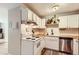 Cozy kitchen featuring white cabinets, butcher block countertops, stainless steel appliances, and a patterned rug at 1390 N Emerson St # 407, Denver, CO 80218