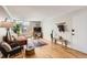 Bright living room featuring hardwood floors, a large window, and contemporary furnishings for a comfortable living space at 1390 N Emerson St # 407, Denver, CO 80218