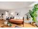 Open living space featuring hardwood floors, plants, modern furnishings and a large mirror at 1390 N Emerson St # 407, Denver, CO 80218