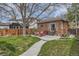 Beautiful backyard with a stone patio, seating area, and lush lawn, offering a serene outdoor space for relaxation and enjoyment at 1023 S High St, Denver, CO 80209