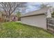 Well-maintained backyard with a lush lawn, a brick house, a spacious garage, and a charming fence, great for outdoor enjoyment at 1023 S High St, Denver, CO 80209