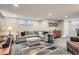 The finished basement has recessed lighting, a comfortable couch, and a vibrant area rug at 1023 S High St, Denver, CO 80209