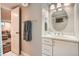 Cozy bathroom featuring a classic white vanity, oval mirror, and easy access to the basement, creating a welcoming space at 1023 S High St, Denver, CO 80209
