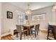 Cozy dining room with rustic wood table, modern chandelier and plenty of natural light at 1023 S High St, Denver, CO 80209