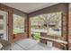 Inviting front porch with brick accents, a cozy bench, and a view of the tree-lined street, perfect for relaxing outdoors at 1023 S High St, Denver, CO 80209