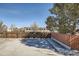 Backyard featuring a brick fence, a wooden fence, and a concrete pad at 2201 S Holly St # 1, Denver, CO 80222