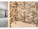 Stylish bathroom featuring a tub with decorative brown tile and mosaic accents at 2201 S Holly St # 1, Denver, CO 80222