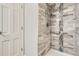 Modern bathroom featuring a tile shower, rainfall shower head and decorative shelving at 2201 S Holly St # 1, Denver, CO 80222