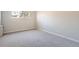 Bright bedroom with neutral carpet and a large window offering natural light at 2201 S Holly St # 1, Denver, CO 80222