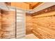 Walk-in closet with wooden cedar walls and built in organizers at 2201 S Holly St # 1, Denver, CO 80222