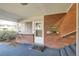 Brick apartment entrance with blue carpet, brick half wall, door with window, and mailboxes at 2201 S Holly St # 1, Denver, CO 80222