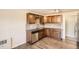 Well-lit kitchen featuring stainless steel appliances, granite countertops, and wood floors at 2201 S Holly St # 1, Denver, CO 80222