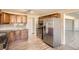 Spacious kitchen with stainless steel appliances, wood cabinets, and tiled backsplash at 2201 S Holly St # 1, Denver, CO 80222