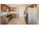 Well-equipped kitchen with modern stainless steel appliances and wooden cabinets at 2201 S Holly St # 1, Denver, CO 80222