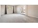 Cozy living room featuring neutral carpet and large glass patio doors leading outside at 2201 S Holly St # 1, Denver, CO 80222