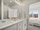 Elegant bathroom featuring dual sinks, modern vanity, and a connecting bedroom at 2721 W 167Th Pl, Broomfield, CO 80023