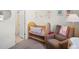 Sweet Bedroom space with neutral tones, a soft rocking chair, and a view to an ensuite bathroom at 2721 W 167Th Pl, Broomfield, CO 80023
